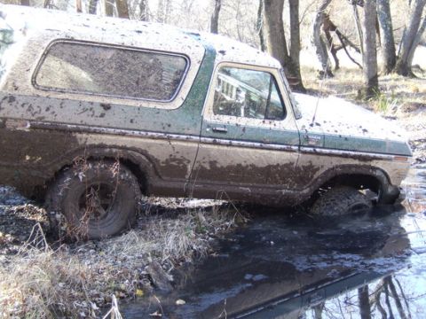 1989 Ford Bronco - This 1978 Ford Bronco is deeply stuck in muddy water, with only its upper body visible.
