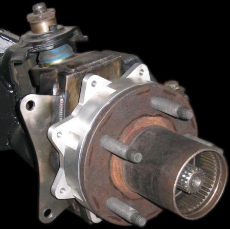 1984 Ford Bronco - This image shows a close-up of a vehicle's front wheel hub assembly, highlighting the rotor, lug nuts, and axle shaft.