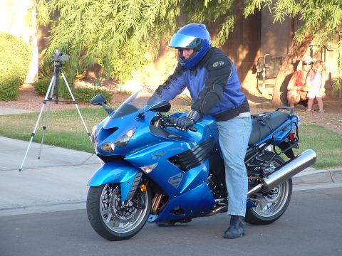2007 Kawasaki Ninja - A rider sits on a blue motorcycle with a Superman logo, a tripod and camera are visible in the background.