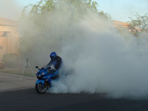 2007 Kawasaki Ninja - Motorcycle burnout creates a large cloud of smoke on a residential street.