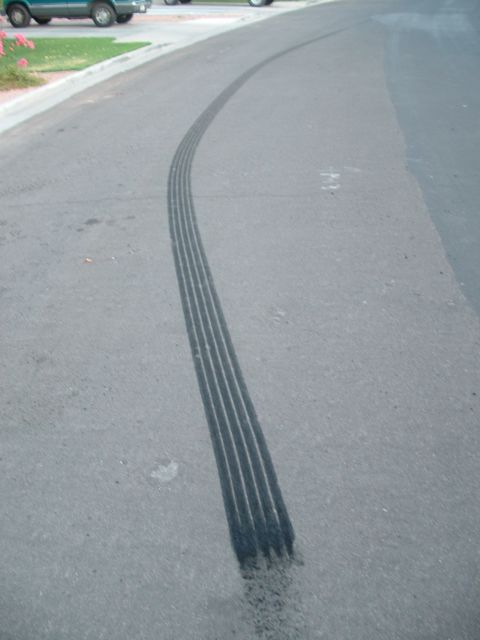 2007 Kawasaki Ninja - Tire marks on asphalt road, curving to the right.