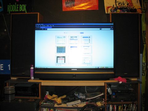 1997 Ford Crown Victoria - A computer setup with a large monitor displaying various web pages, flanked by speakers.