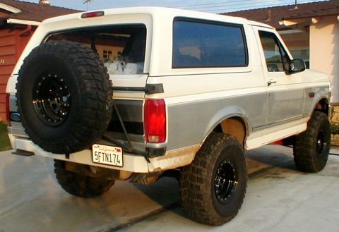 1996 Ford Bronco - This 1996 Ford Bronco is shown from the rear, a prominent spare tire and a California license plate.