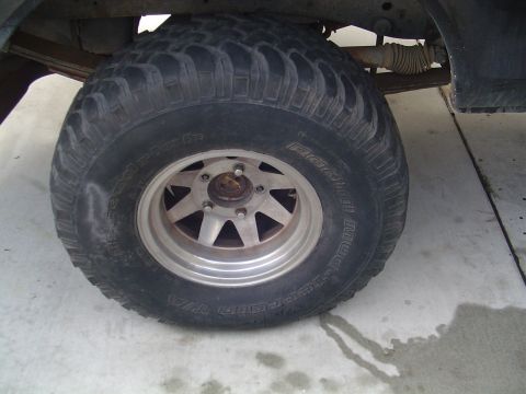 1978 Ford Bronco - Close-up of a BFGoodrich Radial Mud-Terrain T/A tire and wheel assembly, with visible suspension parts.