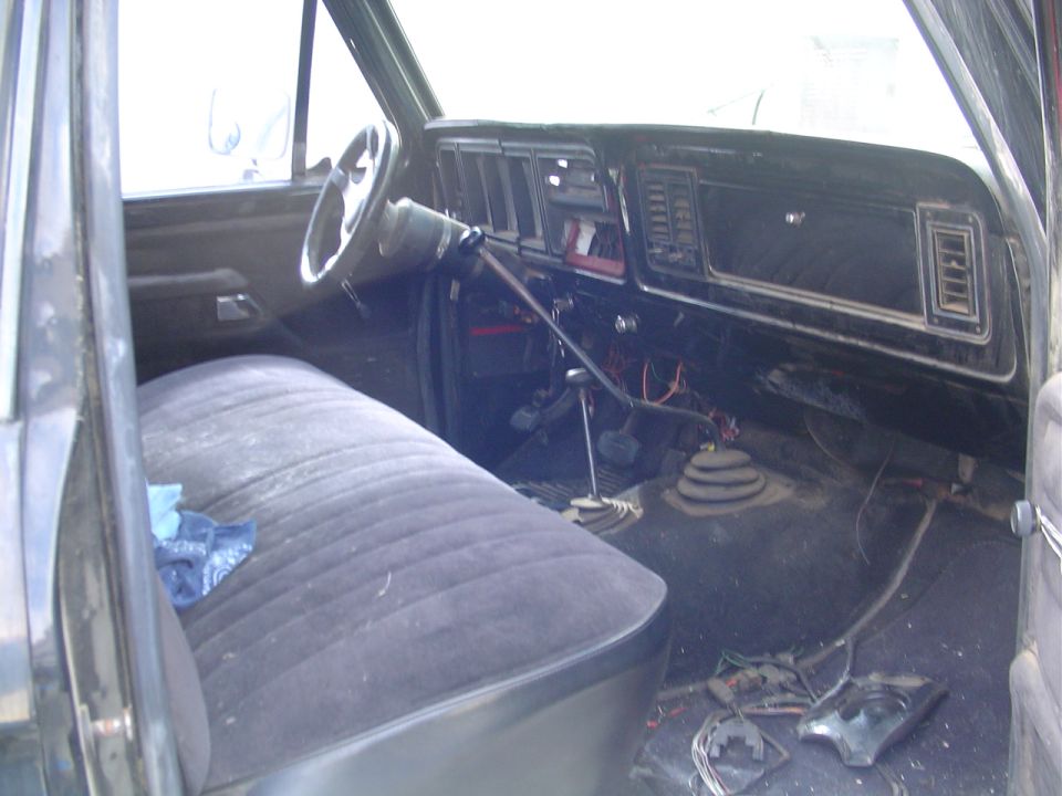 1978 Ford Bronco interior showing bench seat, dashboard, steering wheel, and floor shifter