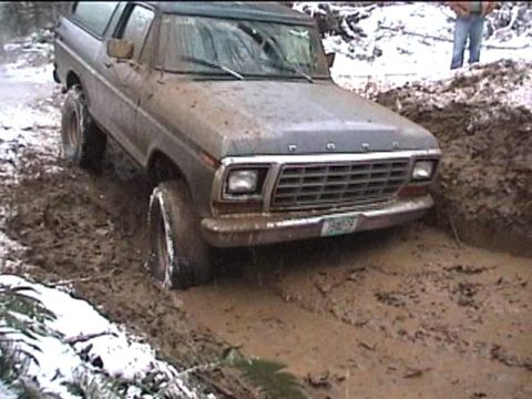 1979 Ford Bronco - This 1978 Ford Bronco is stuck deep in mud, with snow visible on the ground.