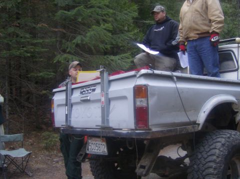 1986 Ford Bronco - People gather in the bed of a Toyota pickup truck during an outdoor event.