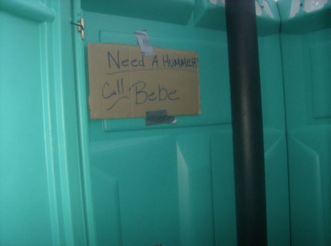 1986 Ford Bronco - A handwritten sign is taped inside a portable toilet, asking for a Hummer and providing a contact name.