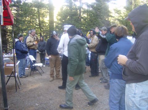 1986 Ford Bronco - People are gathered in a wooded area, possibly for an event or cleanup, with a red tent visible.