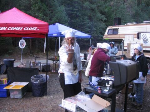 1989 Ford Bronco - Outdoor gathering with people grilling food at a campsite, with tents and an RV in the background.