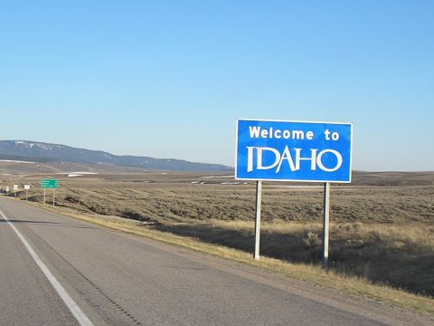1989 Ford F-250 - Entering Idaho on a highway with a welcome sign and a vast, arid landscape.