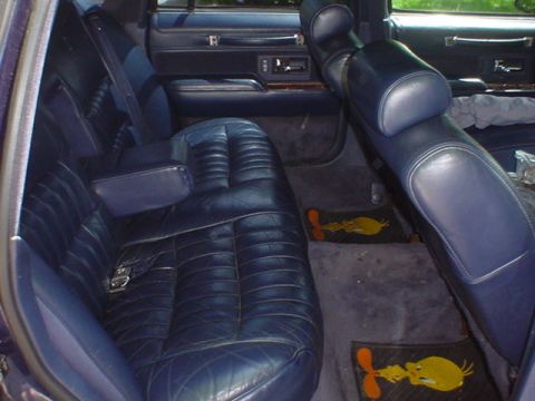 1994 Lincoln Town Car - Interior view of a car's rear seating area with dark blue leather upholstery.