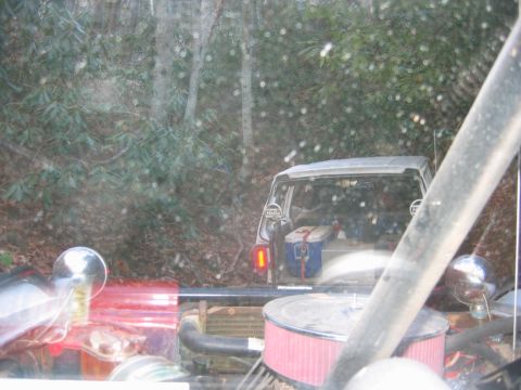 1992 Ford Mustang - Two vehicles are parked in a wooded area, one behind the other. A cooler is visible in the rear of the second vehicle.