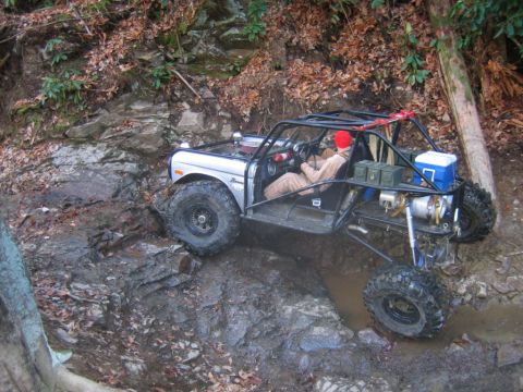 1992 Ford Mustang - A heavily modified off-road vehicle tackles a challenging, wet terrain.