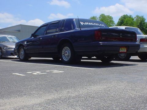 1994 Lincoln Town Car - Rear view of a 1994 Lincoln Town Car, parked next to another vehicle.