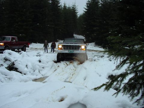 1979 Ford Bronco - A 1979 Ford Bronco navigates a snowy trail with another truck visible in the background.