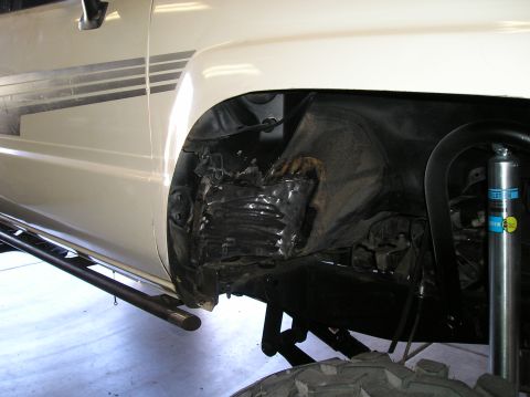 1986 Toyota Hilux - Close-up of the wheel well and suspension on a 1986 Toyota Hilux.