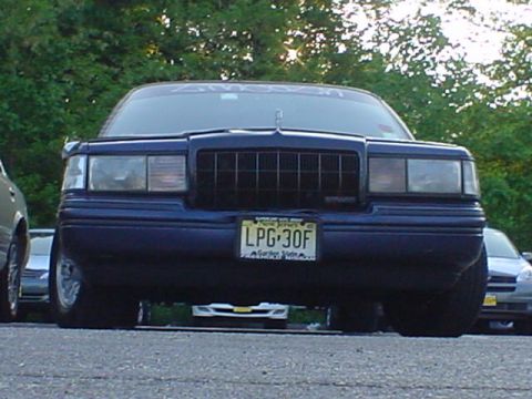 1994 Lincoln Town Car - Front view of a dark blue sedan with a prominent grille and license plate.