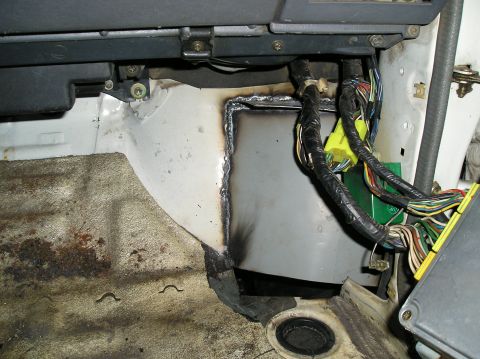 1986 Toyota Hilux - Close-up view of a vehicle's interior firewall showing modifications and wiring harnesses.