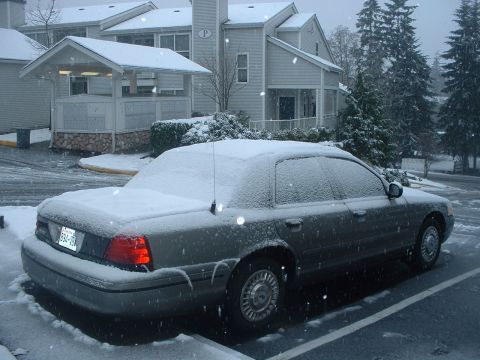 2000 Ford Crown Victoria - A 2000 Ford Crown Victoria is covered in snow during a winter storm.