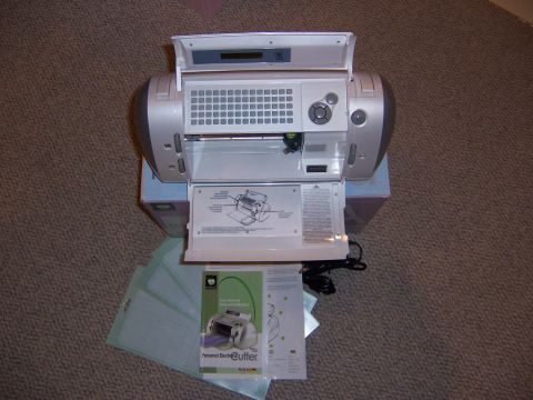 1987 Ford Bronco - A personal electronic cutting machine is shown with its manual and several cutting mats on a carpeted surface.