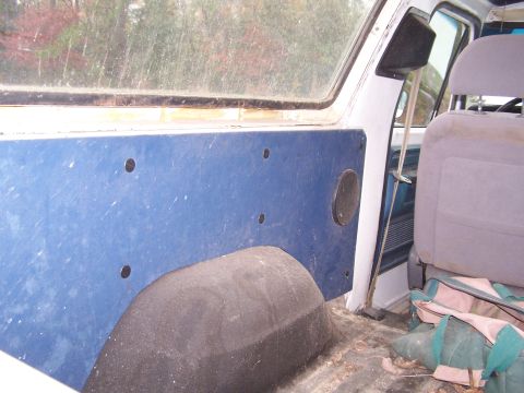 1979 Ford Bronco - Interior view of a vehicle's rear passenger side, showing the door panel and wheel well.