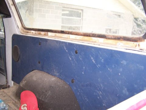 1979 Ford Bronco - Interior view showing a blue panel, speaker, and wheel well.