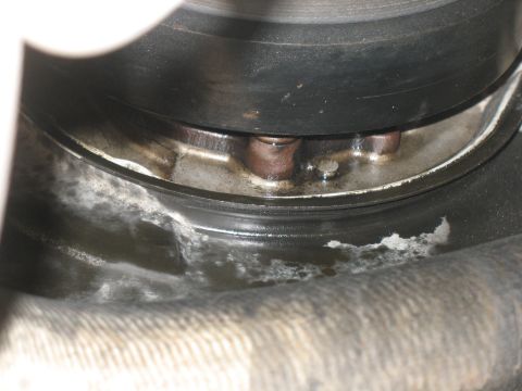 2001 Ford F-250 - This image shows a close-up of a dirty automotive part, likely from a vehicle's drivetrain or wheel assembly.