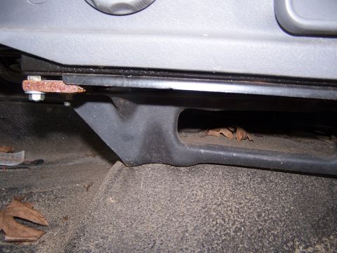 1979 Ford Bronco - Detail of a seat mounting bracket, showing rust and surrounding interior trim.