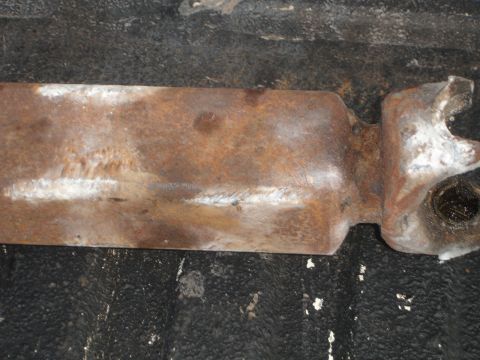 1989 Ford Bronco - Close-up of a rusted metal part with some white markings visible.