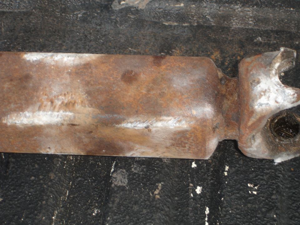 rusted metal part with white markings