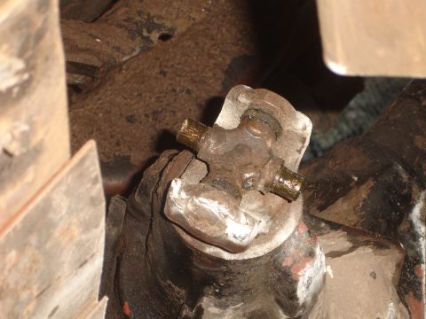 1989 Ford Bronco - Universal joint from a vehicle's drivetrain, showing wear and grease fittings.