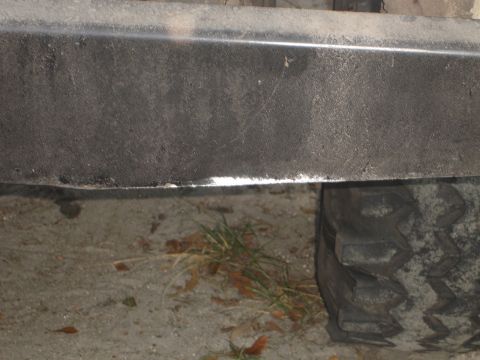 1989 Ford Bronco - Detail shot of a vehicle's bumper and tire tread.