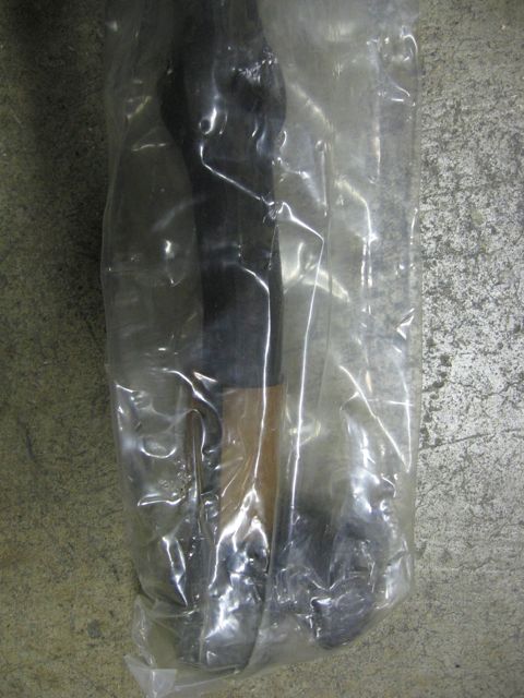 1989 Ford Bronco - This image shows a part contained within a plastic bag, with no discernible vehicle details visible.