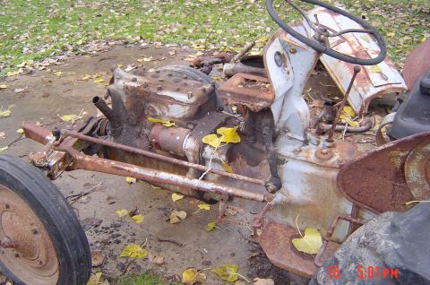 1946 Ford F1 - This heavily rusted tractor appears to be missing many of its body panels and is in a state of disrepair.