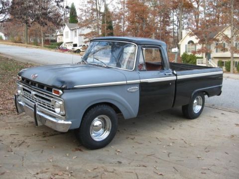 1966 Ford F-100 - This 1966 Ford F-100 pickup truck features a two-tone gray and black paint scheme and chrome wheels.