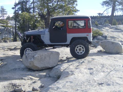 1986 Ford Bronco - This modified Toyota Land Cruiser FJ40 is shown off-roading over large rocks.