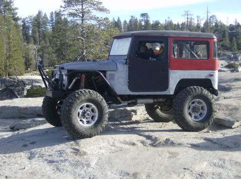 1986 Ford Bronco - This heavily modified off-road vehicle is parked on a rocky terrain.