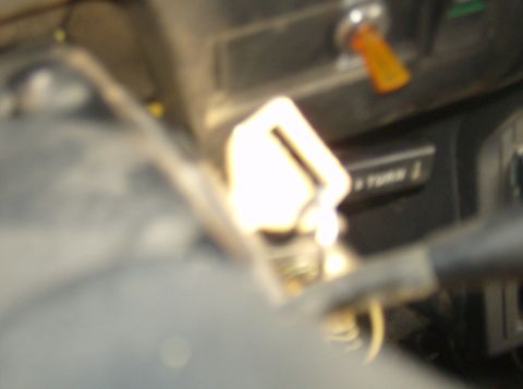 1986 Ford Bronco - Close-up of a vehicle's interior dashboard, showing the ignition and a turn signal lever. Text on a nearby panel reads 'TURN'.