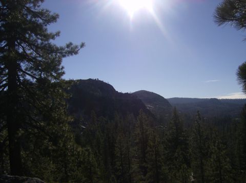 1986 Ford Bronco - A wide view of a mountainous, forested landscape under a bright, sunny sky.