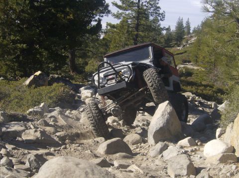 1986 Ford Bronco - This vehicle is shown off-roading on a challenging, rocky path.
