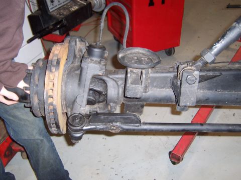 1990 Ford Bronco - Close-up of a Dana 60 front axle assembly, showing brake components and steering linkage.