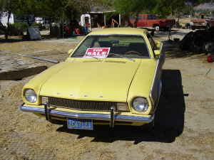 1970 Ford Ranchero - This yellow 1970 Ford Ranchero is seen from the front 3/4 angle with a "FOR SALE" sign on the windshield.