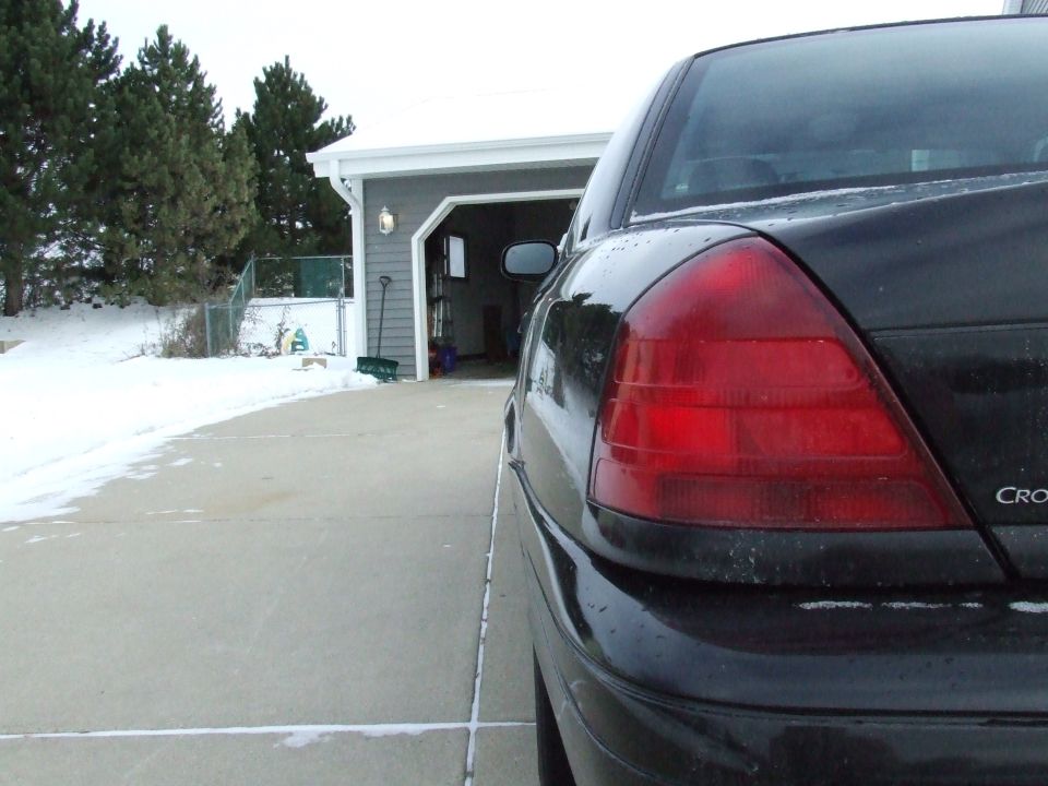 Black sedan rear quarter view, 2003 Ford Crown Victoria