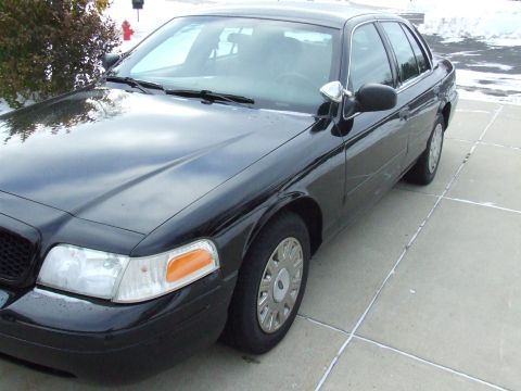 2003 Ford Crown Victoria - A black 2003 Ford Crown Victoria is shown from a three-quarter front angle on a paved surface.