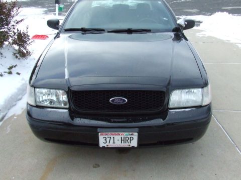 2003 Ford Crown Victoria - Front view of a black 2003 Ford Crown Victoria with a black grille and a Wisconsin license plate.