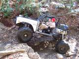 1992 Ford Mustang - Remote-controlled rock crawler truck navigating a challenging, rocky trail.