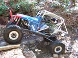 1992 Ford Mustang - A custom-built buggy tackles a challenging off-road course with steep inclines and loose rocks.