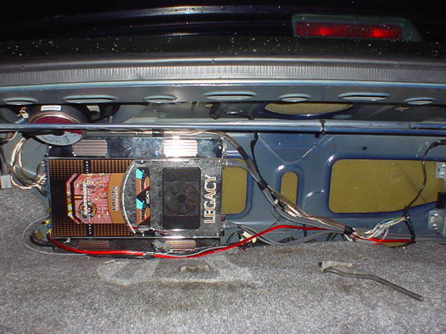 Trunk-mounted Legacy amplifier and wiring in a car audio install