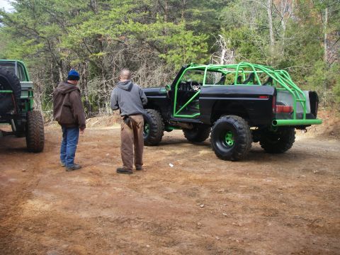 1978 Ford Bronco - Modified 1978 Ford Bronco with custom green roll cage and off-road tires.